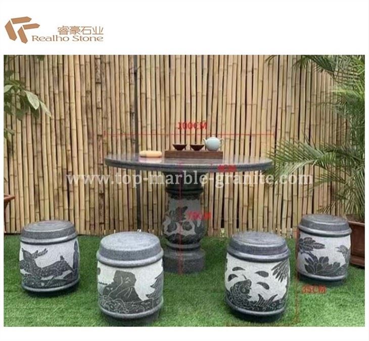 Dark granite table and chair with carving
